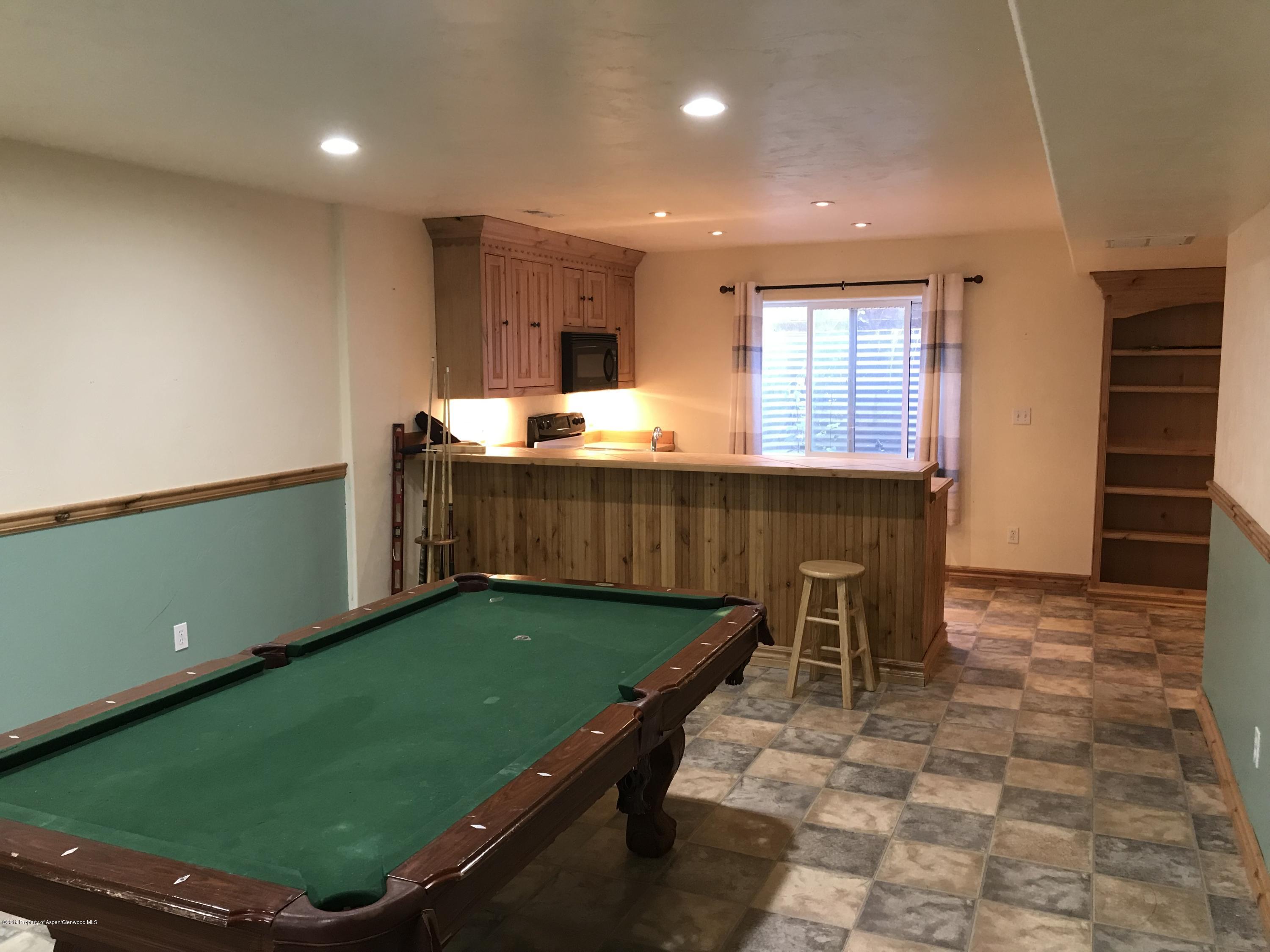 525 Birch Court Rifle, CO 81650 - Photo 15 of 17 a room with pool table and windows