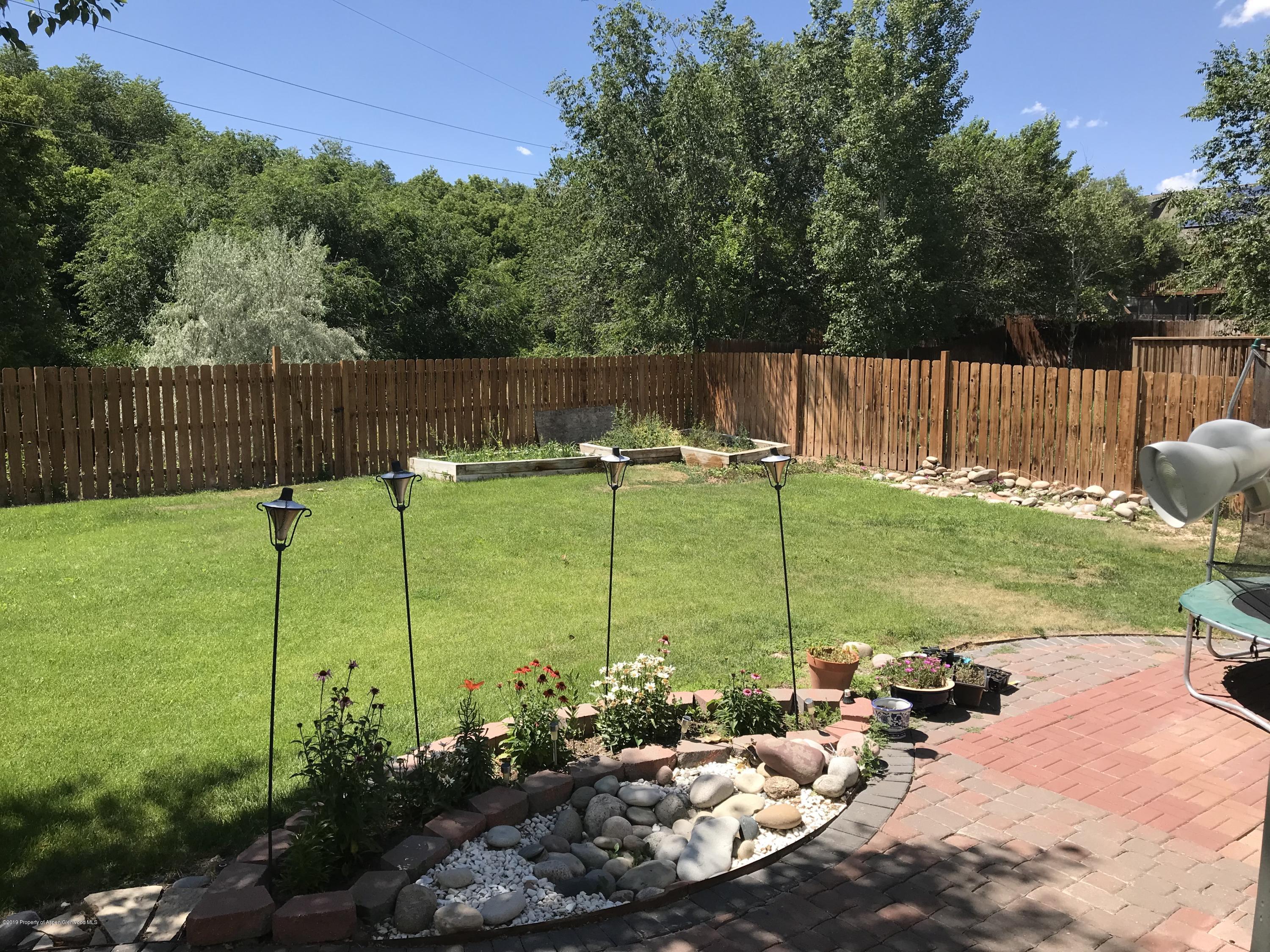 525 Birch Court Rifle, CO 81650 - Photo 17 of 17 a view of a garden with houses