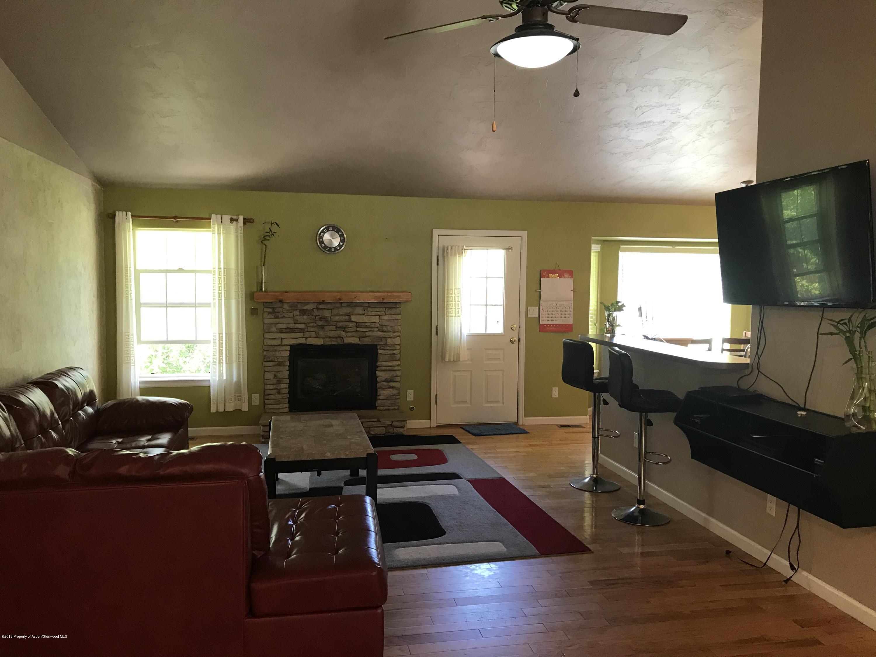 525 Birch Court Rifle, CO 81650 - Photo 3 of 17 a living room with furniture and a flat screen tv