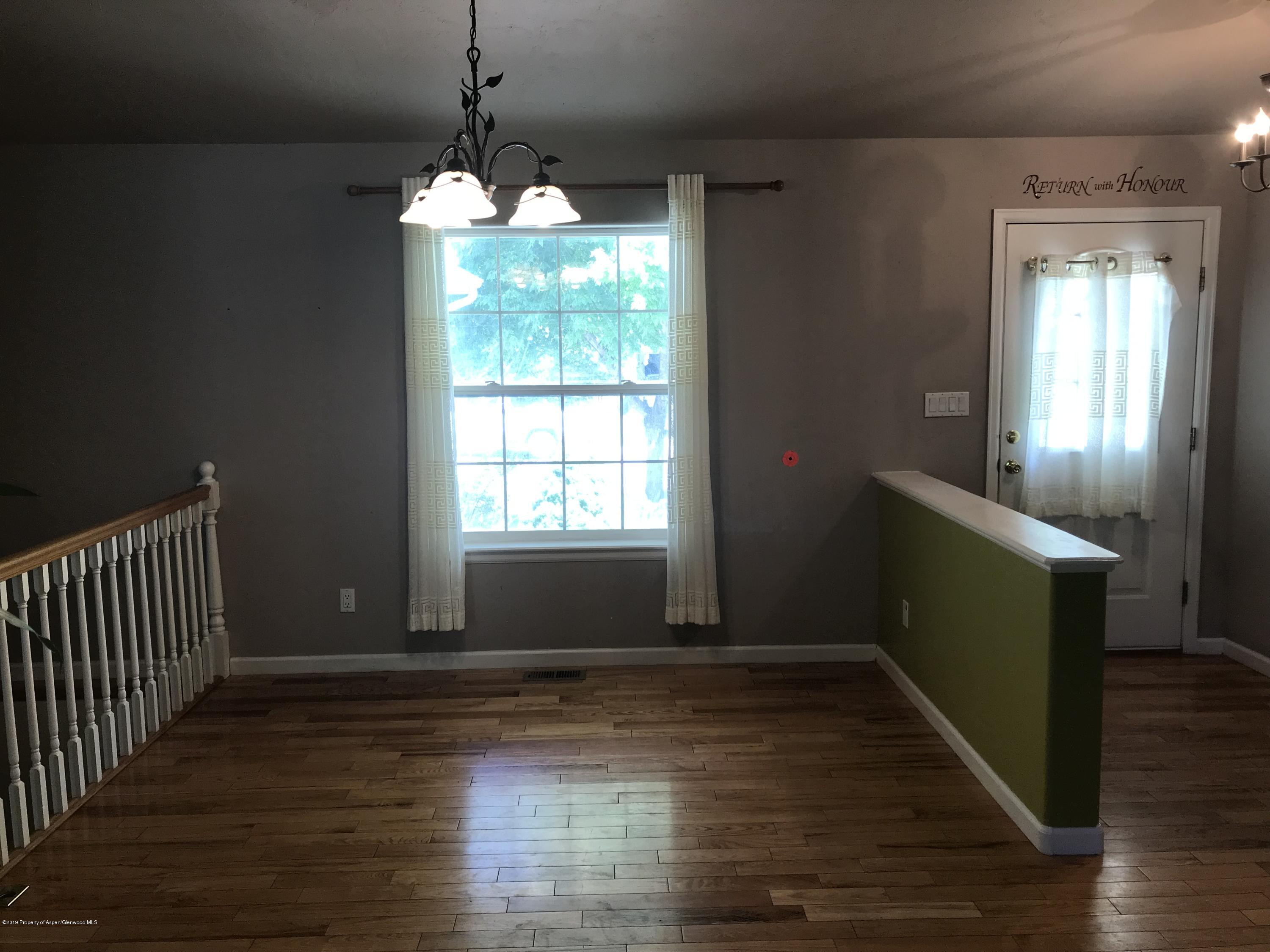 525 Birch Court Rifle, CO 81650 - Photo 7 of 17 a room with wooden floor and windows