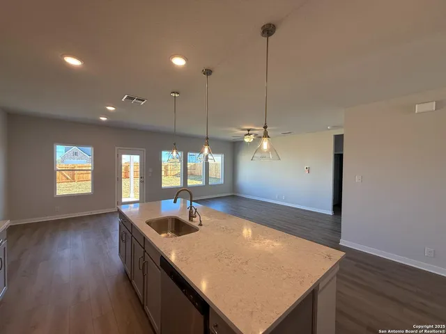 a view of kitchen and living room with wooden floor