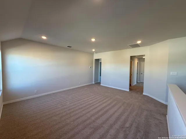 an empty room with a empty space and windows