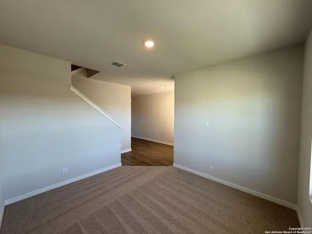a large kitchen with kitchen island a stove a sink a window and wooden floor