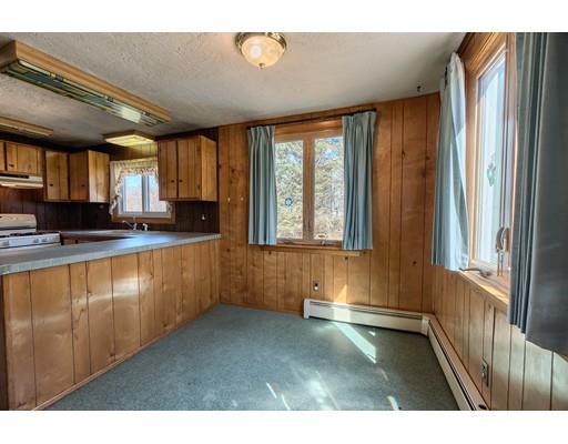 7 Ellis Road Southbridge, MA 01550 - Photo 4 of 30 a kitchen with stainless steel appliances granite countertop a refrigerator a sink dishwasher a stove and a large window with wooden floor