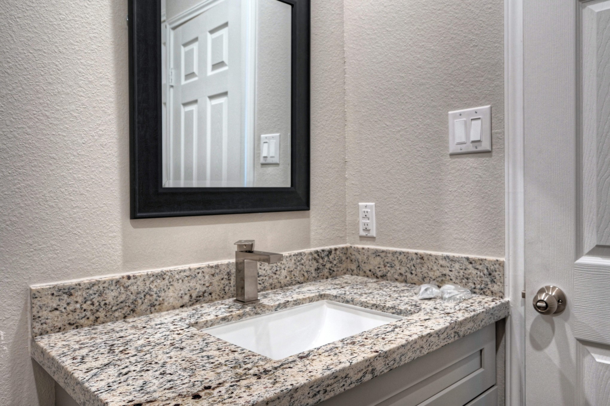 9173 Inwood Willis, TX 77318 - Photo 27 of 31 a bathroom with a granite countertop sink and mirror