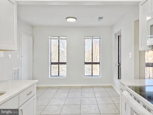a kitchen with white cabinets and a sink