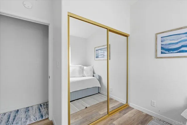 a bedroom with a bed and a mirror
