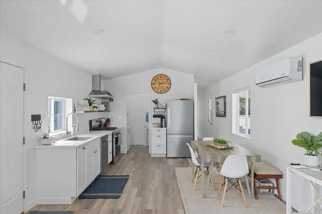 a view of a kitchen area with furniture and wooden floor