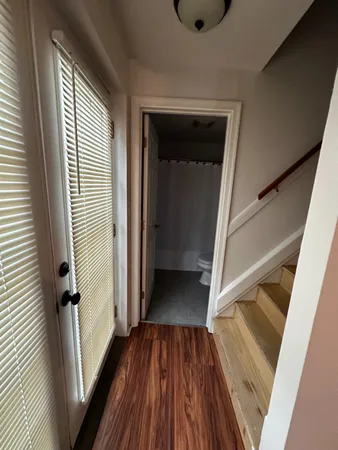 a view of a hallway view with wooden floor and staircase