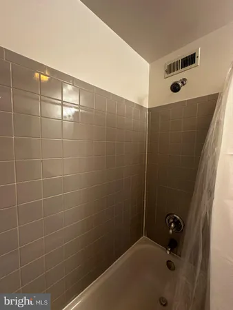 a bathroom with a bathtub and shower