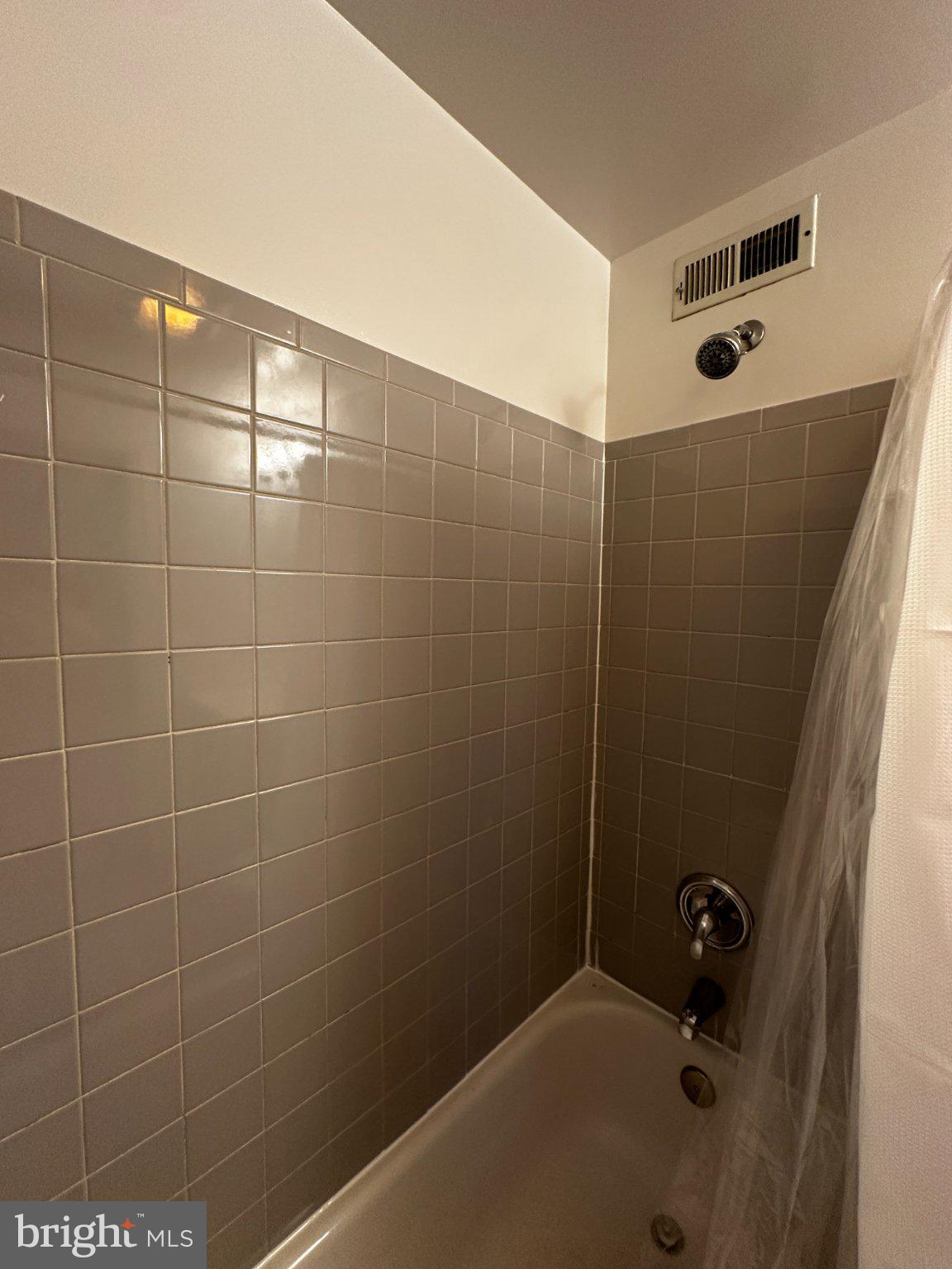 1527 West 36th Street Baltimore, MD 21211 - Photo 17 of 26 a bathroom with a bathtub and shower