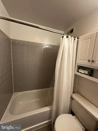 a bathroom with a shower and a toilet