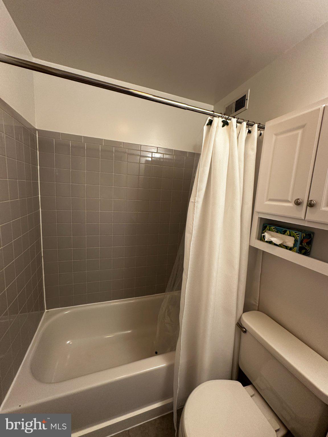 1527 West 36th Street Baltimore, MD 21211 - Photo 18 of 26 a bathroom with a shower and a toilet