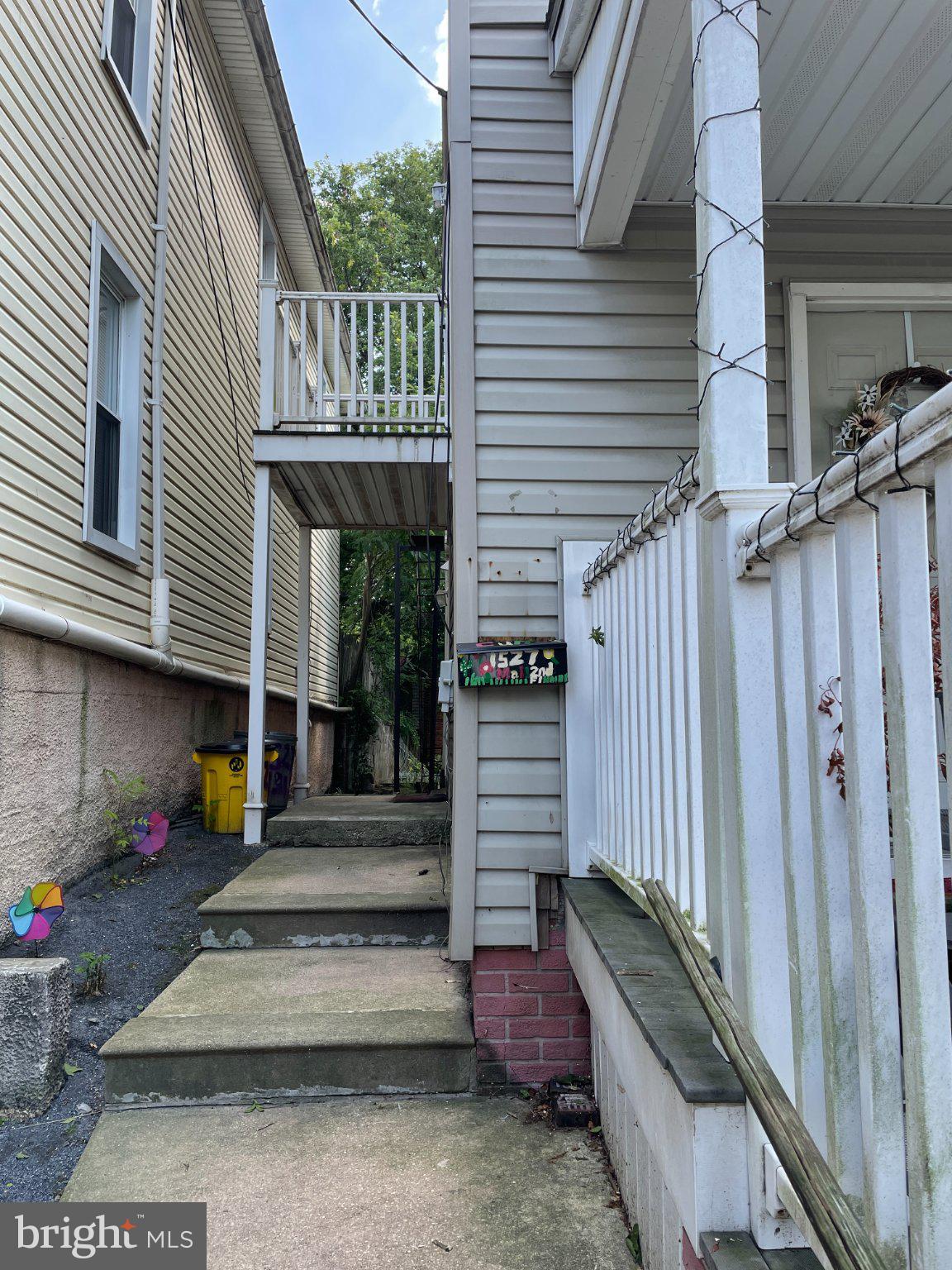 1527 West 36th Street Baltimore, MD 21211 - Photo 2 of 26 a view of a patio with table and chairs potted plants with wooden floor and fence