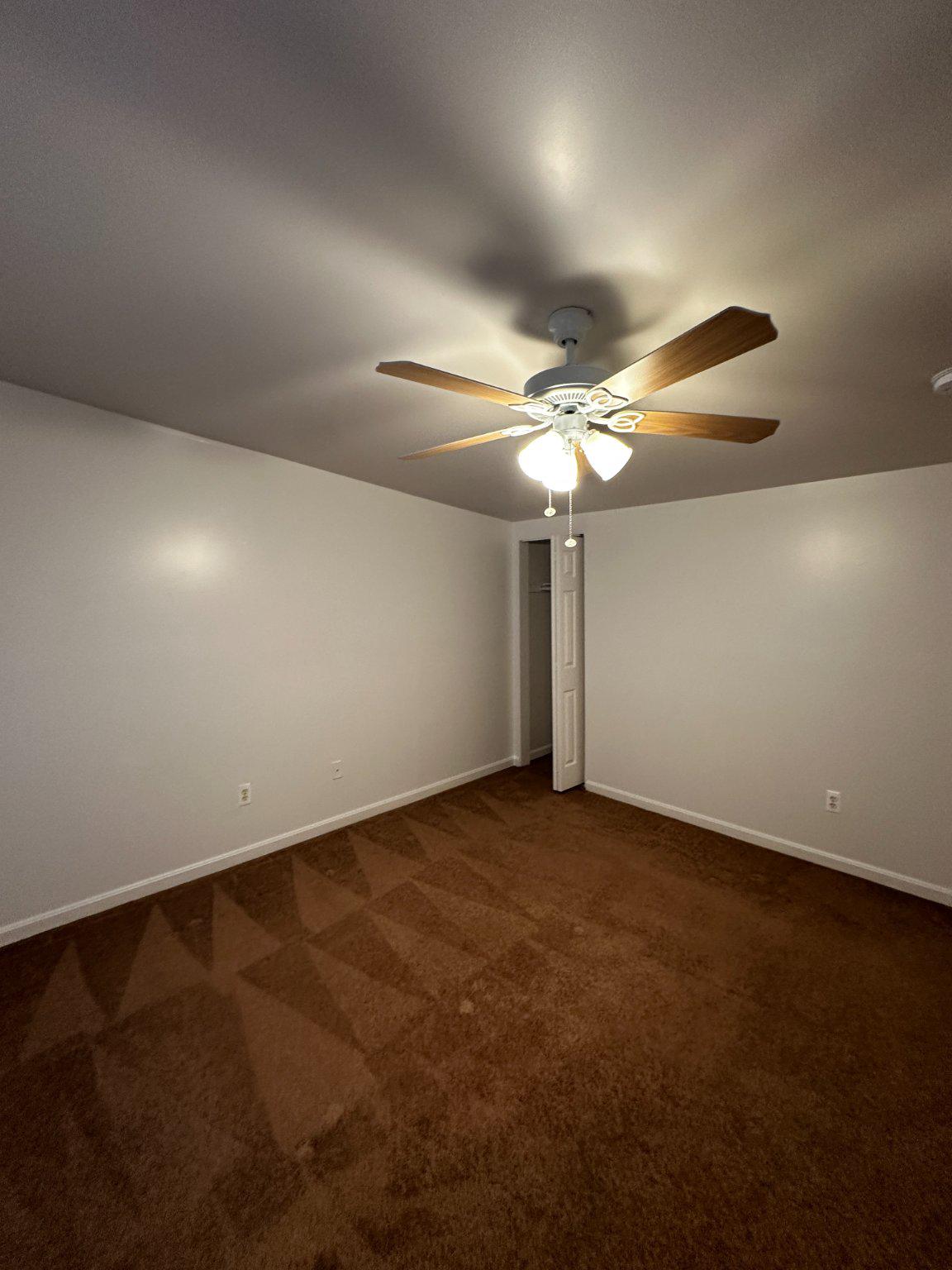 1527 West 36th Street Baltimore, MD 21211 - Photo 26 of 26 a view of an empty room with a chandelier fan