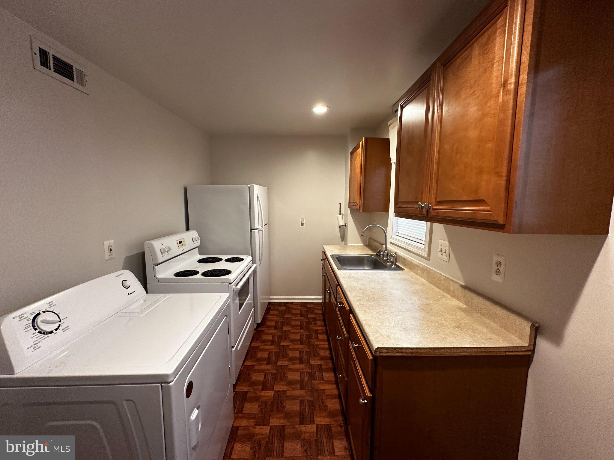 1527 West 36th Street Baltimore, MD 21211 - Photo 5 of 26 a kitchen that has a sink and a stove