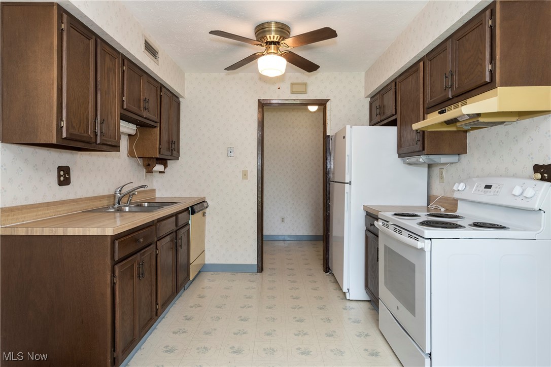 6533 Engle Road Brook Park, OH 44142 - Photo 14 of 38 Kitchen featuring white appliances, under cabinet range hood and ceiling fan
