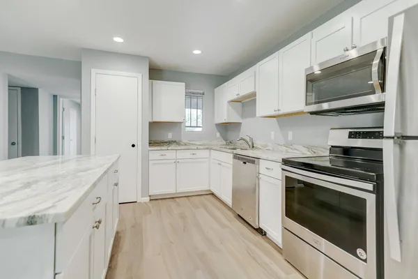 a kitchen with a stove microwave and sink
