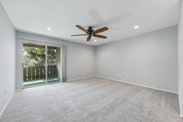 a view of a livingroom with a ceiling fan a window and a ceiling fan