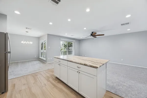 a kitchen with a sink stove and cabinets