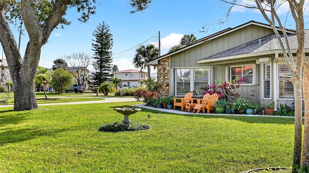 1100 South Riverside Drive Edgewater, FL 32132 - Photo 11 of 57 a view of a house with a big yard potted plants and large tree