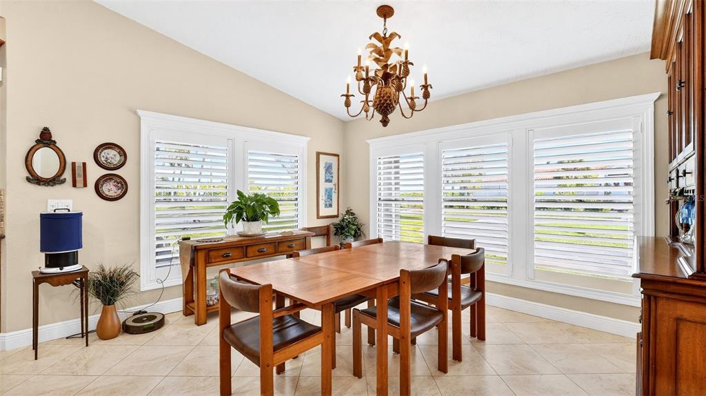 1100 South Riverside Drive Edgewater, FL 32132 - Photo 22 of 57 a dining room with furniture a rug and a chandelier