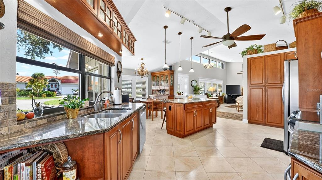 1100 South Riverside Drive Edgewater, FL 32132 - Photo 25 of 57 a kitchen with stainless steel appliances granite countertop a sink a stove and a refrigerator