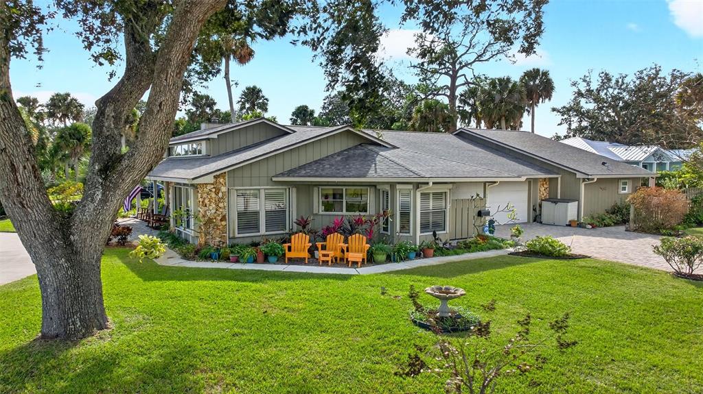 1100 South Riverside Drive Edgewater, FL 32132 - Photo 5 of 57 a front view of a house with garden and trees