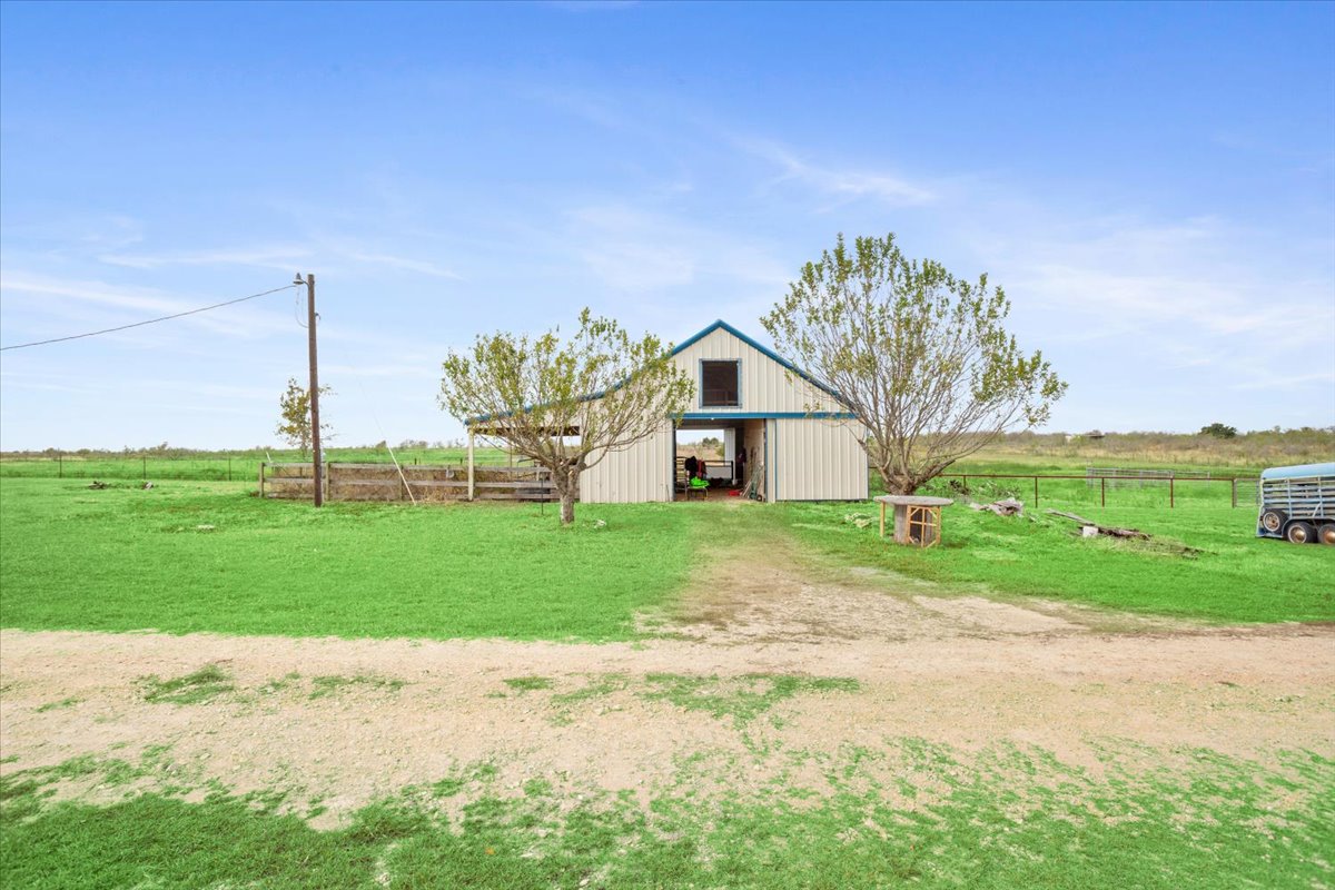 8600 Five Wells Road Rogers, TX 76569 - Photo 38 of 40 View of yard with a pole building, a view of countryside, and an outbuilding