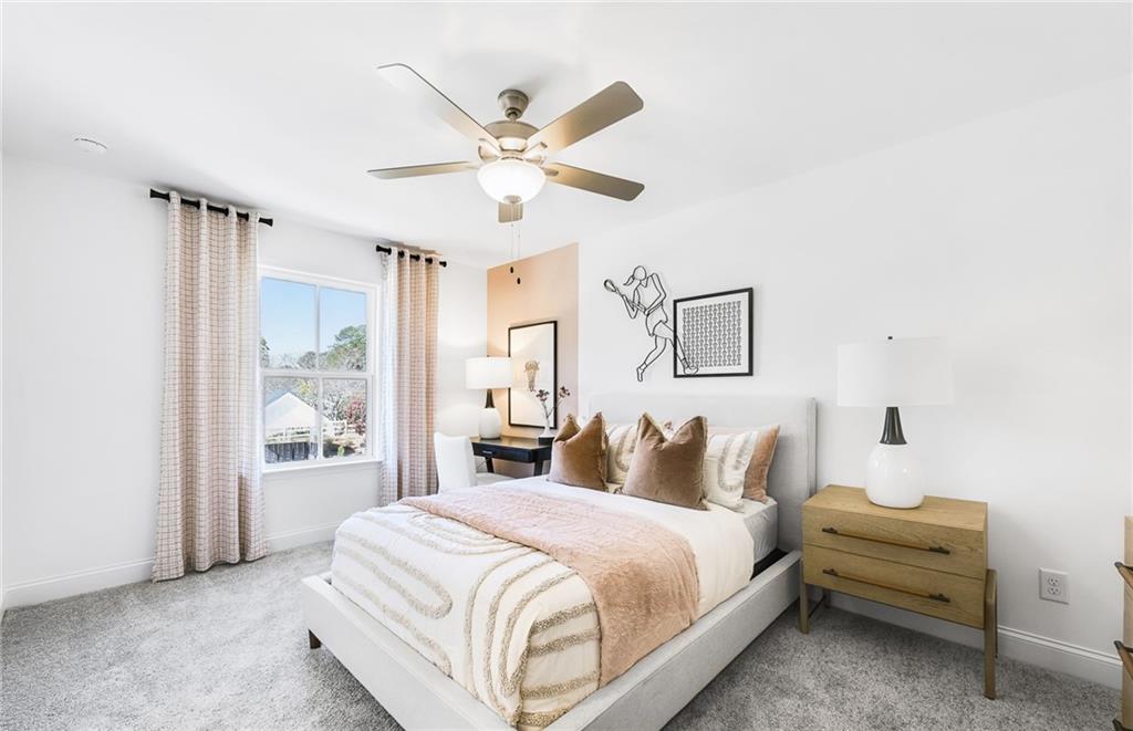 2102 Cayman Court Dacula, GA 30019 - Photo 13 of 18 a bedroom with a large bed and a chandelier