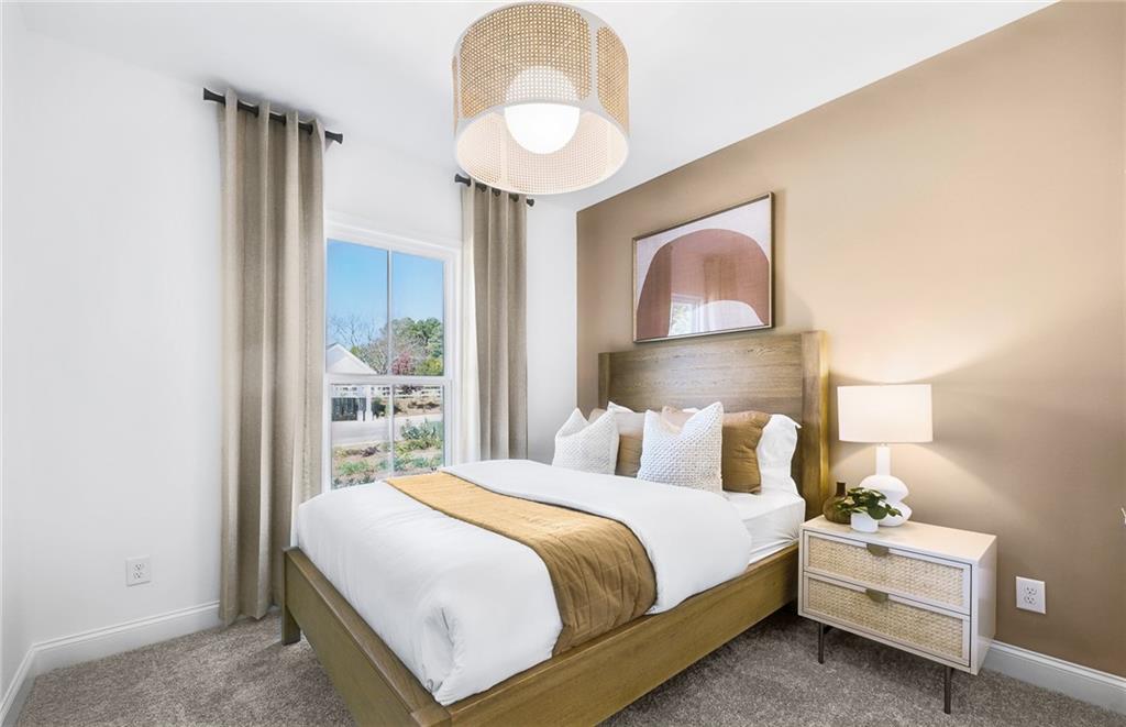 2102 Cayman Court Dacula, GA 30019 - Photo 8 of 18 a bedroom with a bed and a painting on the wall