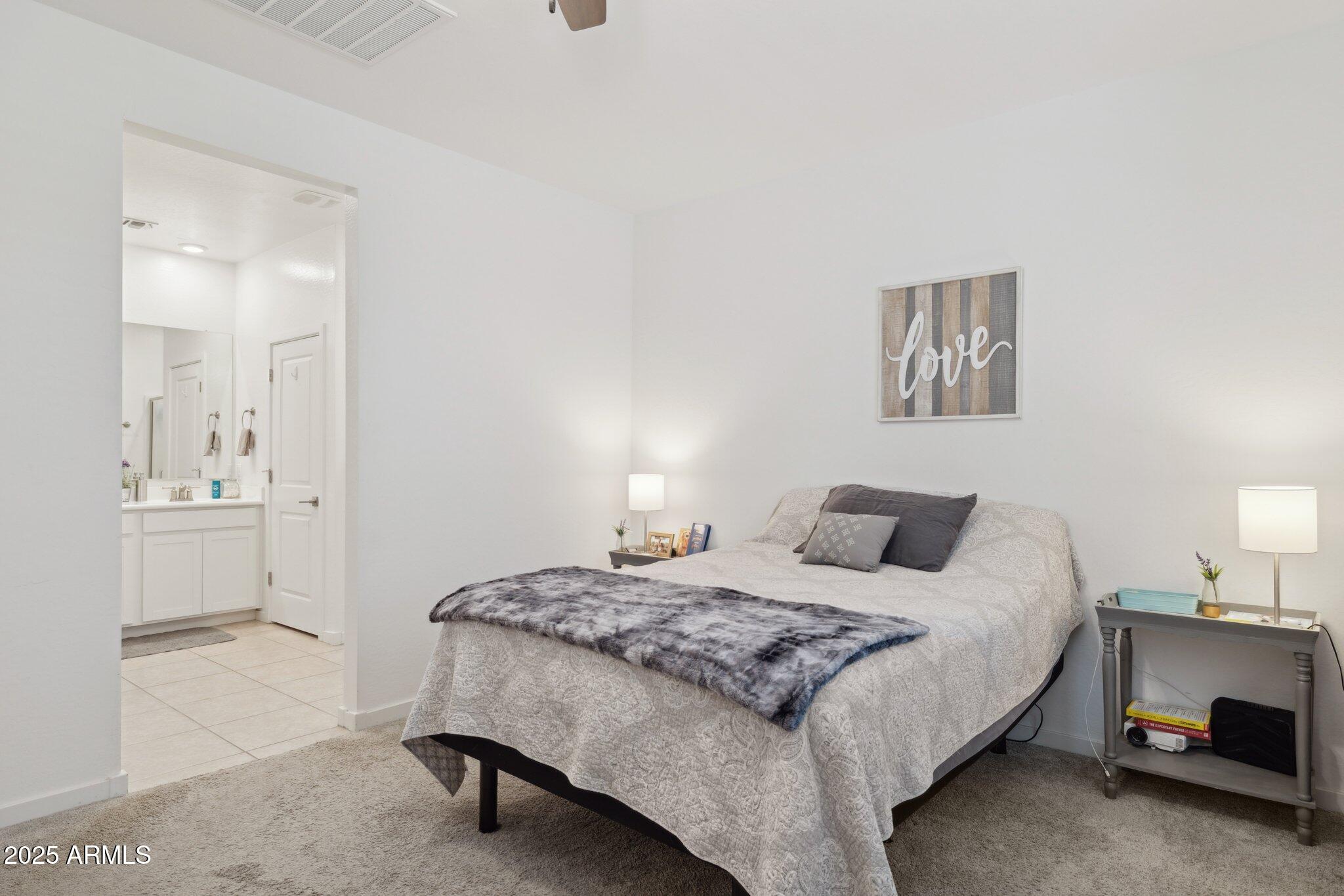 14360 West Pershing Street Surprise, AZ 85379 - Photo 11 of 24 a bedroom with a bed and a lamp on dresser