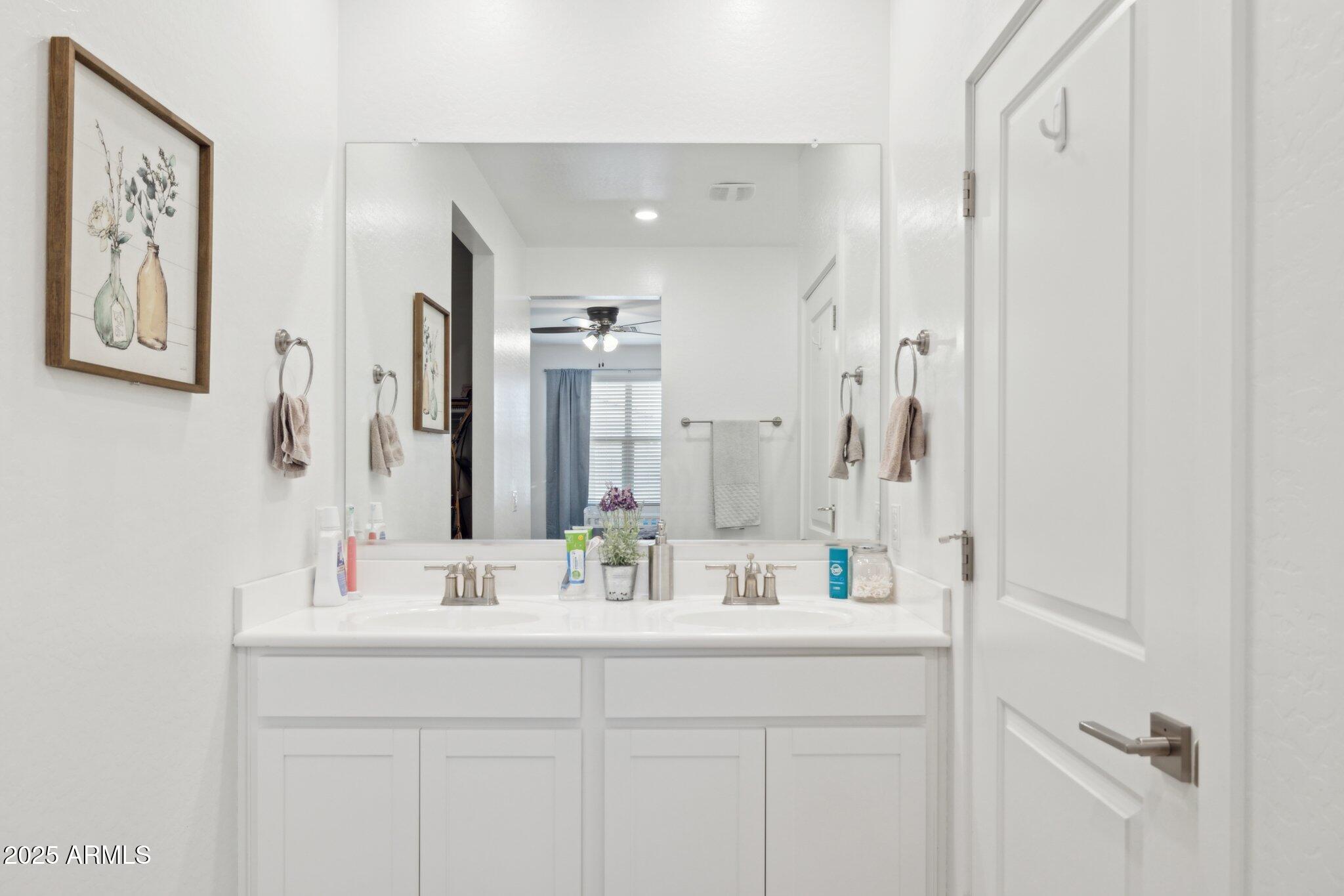 14360 West Pershing Street Surprise, AZ 85379 - Photo 13 of 24 a bathroom with a sink double vanity and a mirror