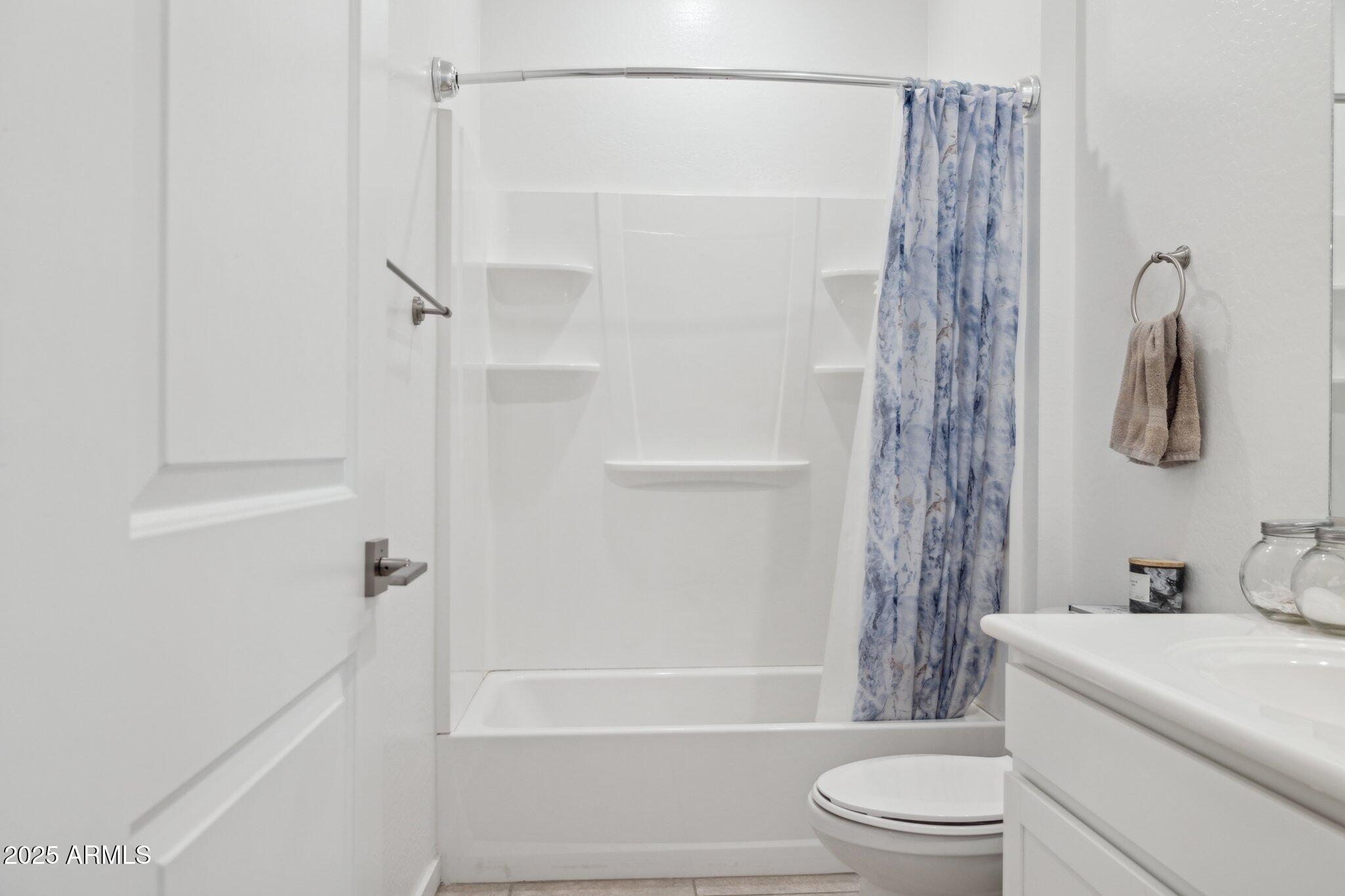 14360 West Pershing Street Surprise, AZ 85379 - Photo 17 of 24 a bathroom with a shower a toilet and a sink