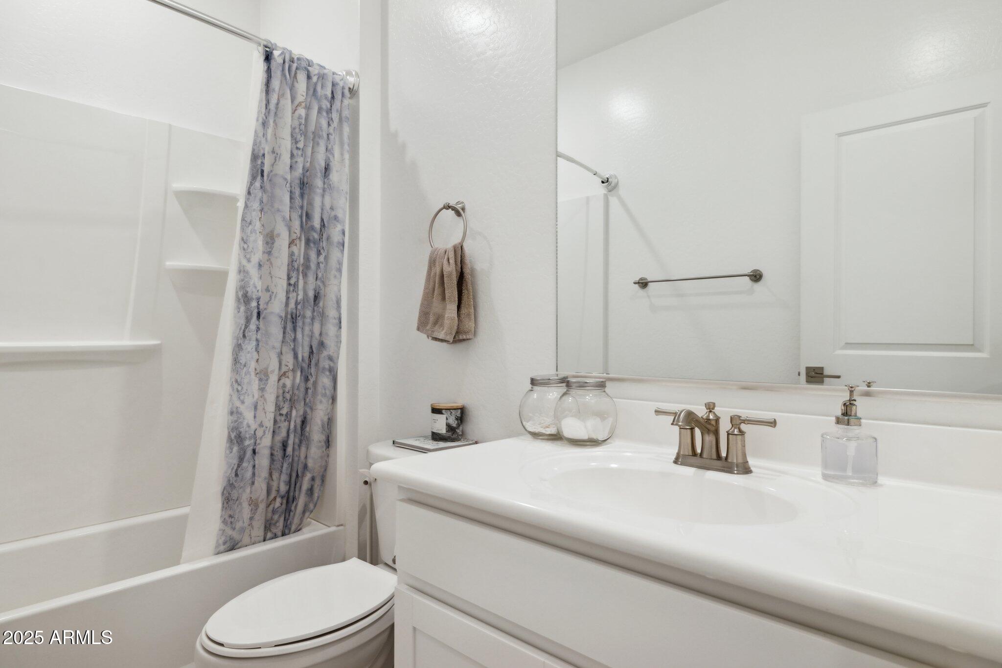 14360 West Pershing Street Surprise, AZ 85379 - Photo 18 of 24 a bathroom with a sink toilet and shower