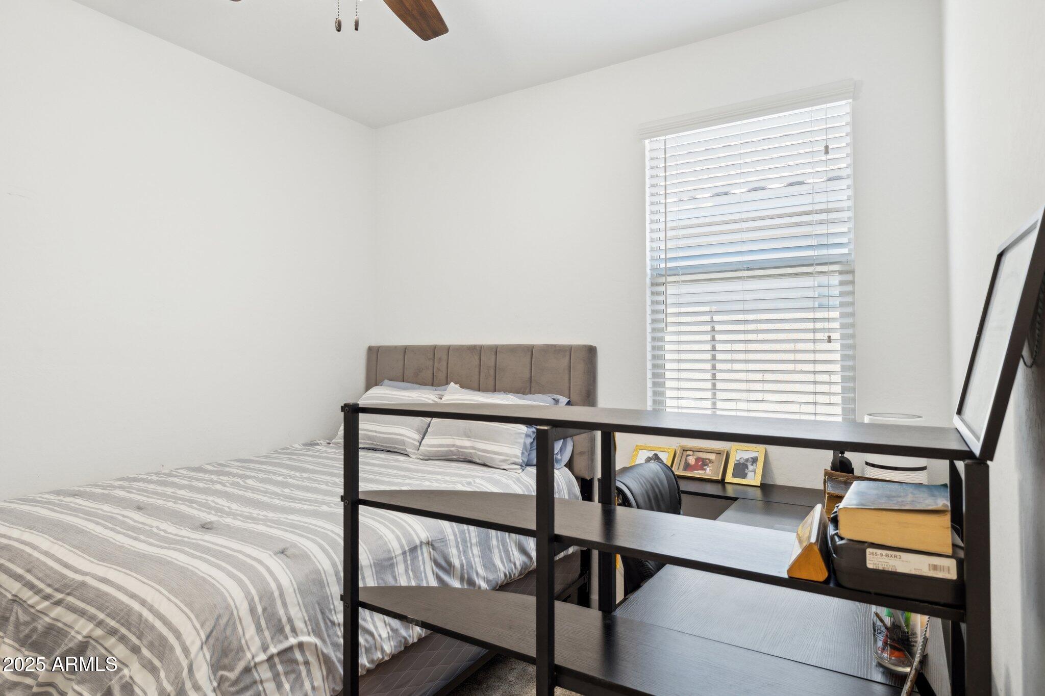 14360 West Pershing Street Surprise, AZ 85379 - Photo 19 of 24 a bedroom with a bed and a window