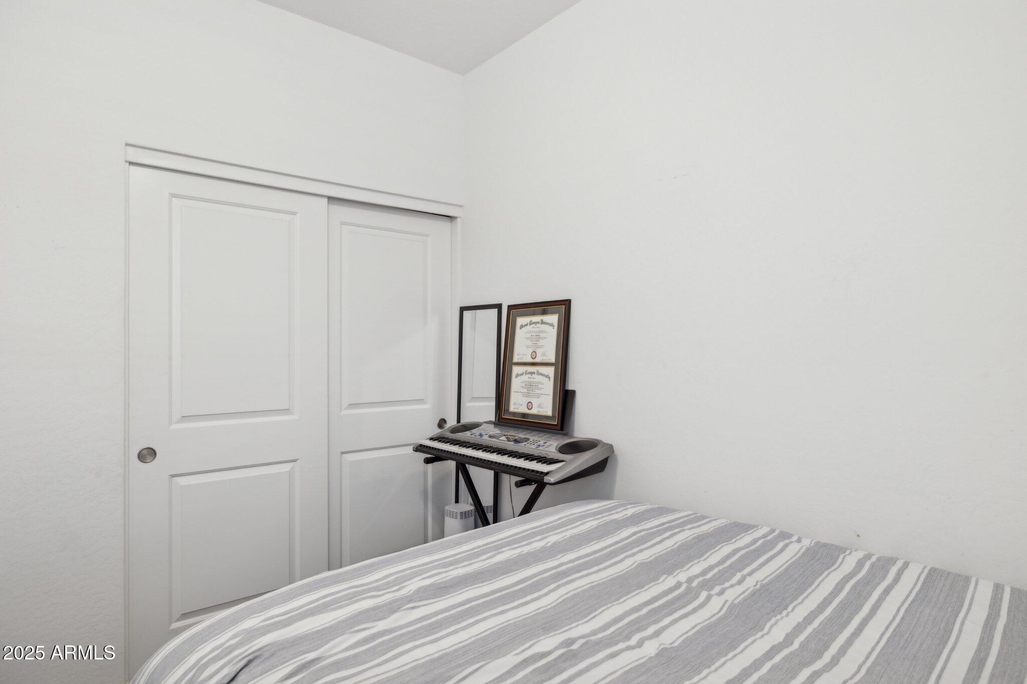 14360 West Pershing Street Surprise, AZ 85379 - Photo 20 of 24 a bedroom with a bed and a window