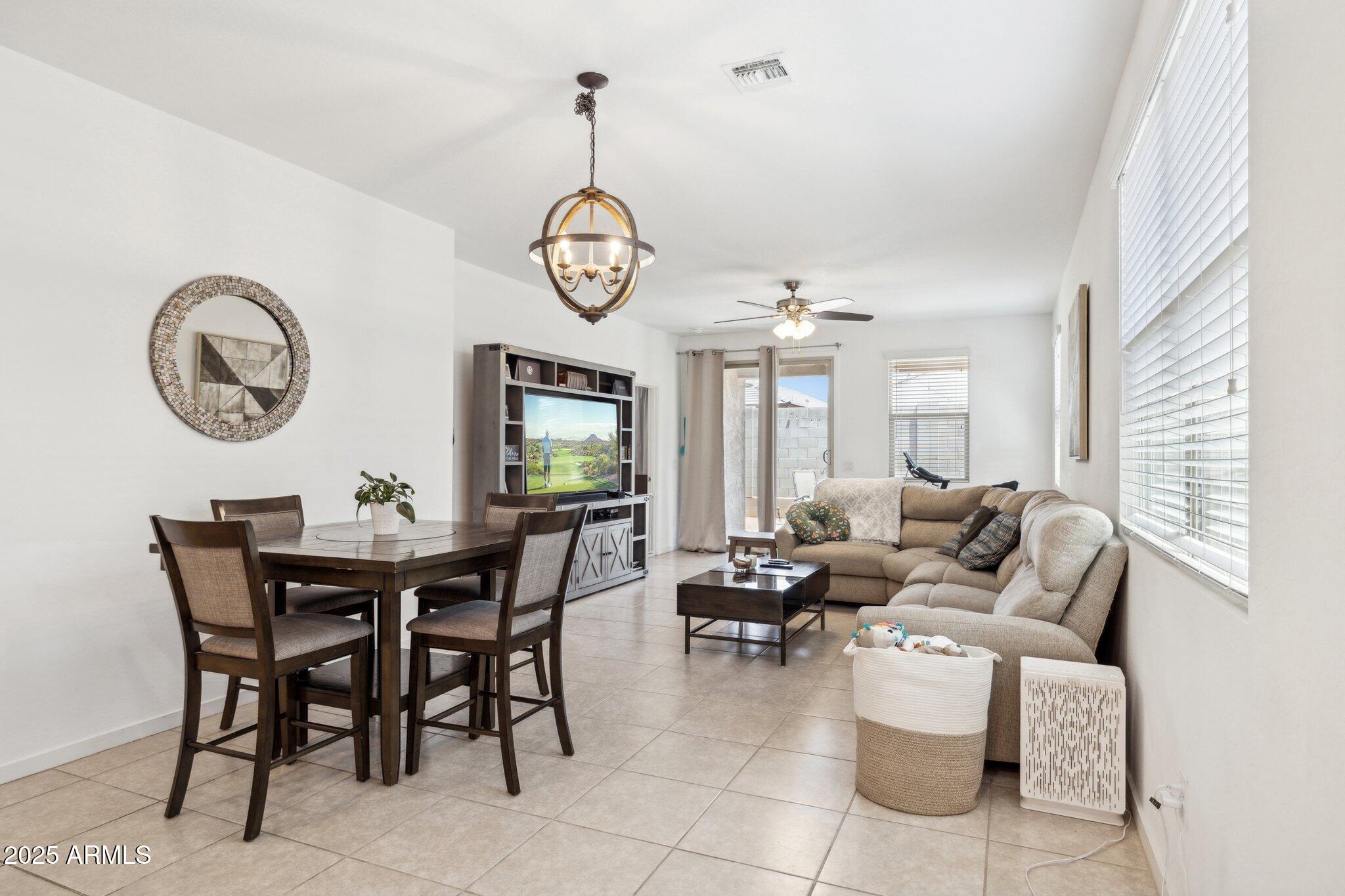 14360 West Pershing Street Surprise, AZ 85379 - Photo 3 of 24 a view of a dining room and hall with furniture