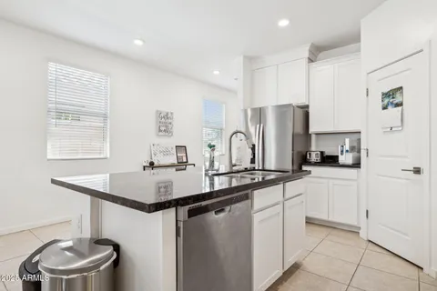 a kitchen with center island table and chairs