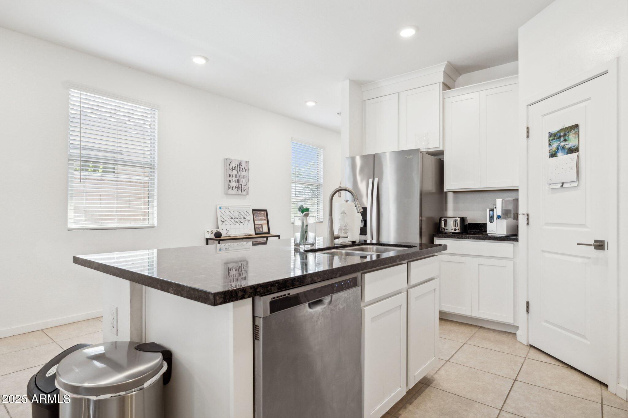 14360 West Pershing Street Surprise, AZ 85379 - Photo 8 of 24 a kitchen with stainless steel appliances a sink and a refrigerator