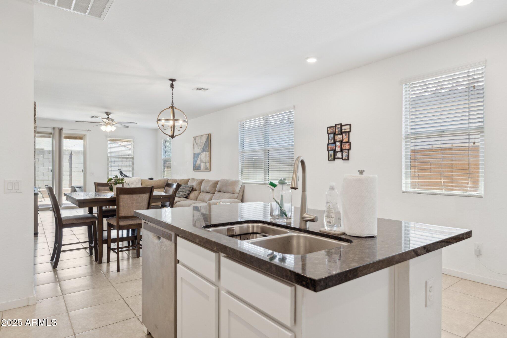 14360 West Pershing Street Surprise, AZ 85379 - Photo 9 of 24 a kitchen with center island table and chairs