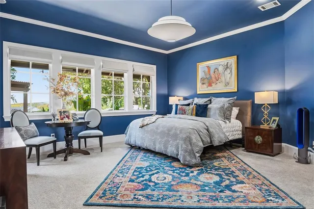 a bedroom with furniture and a rug