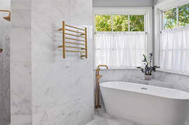 a bathroom with a bathtub and a sink