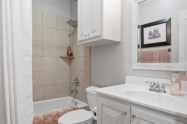 a bathroom with a toilet a sink and shower