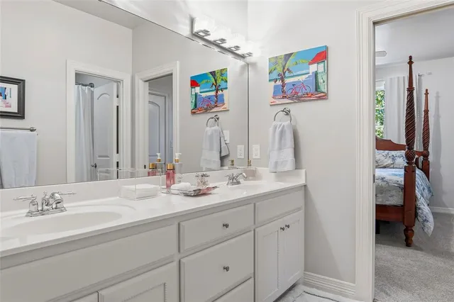 a bathroom with double vanity sinks a vanity and a mirror