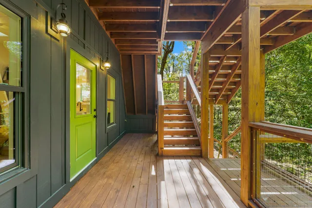 a view of a room with wooden floor and windows
