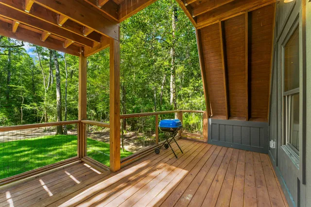 a view of a deck with wooden floor and outdoor seating