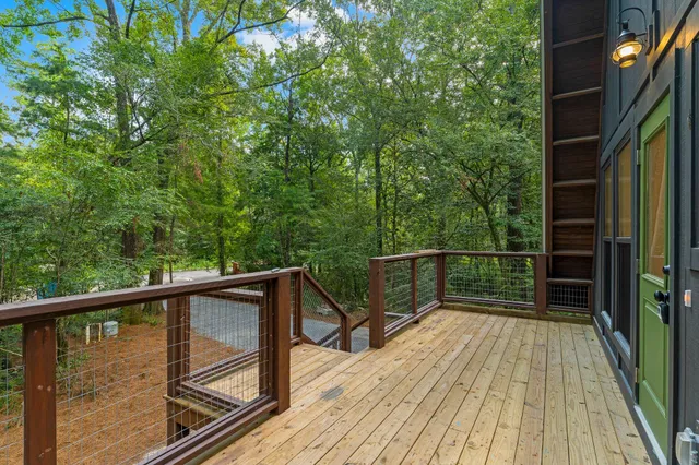 a view of balcony with wooden floor and fence