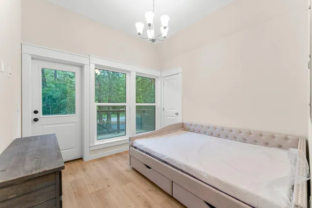 a view of bedroom with furniture and large window