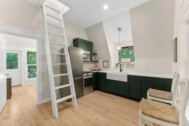 a kitchen with cabinets and window